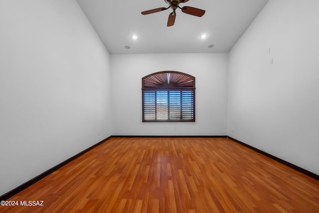 empty room with light hardwood / wood-style flooring and ceiling fan