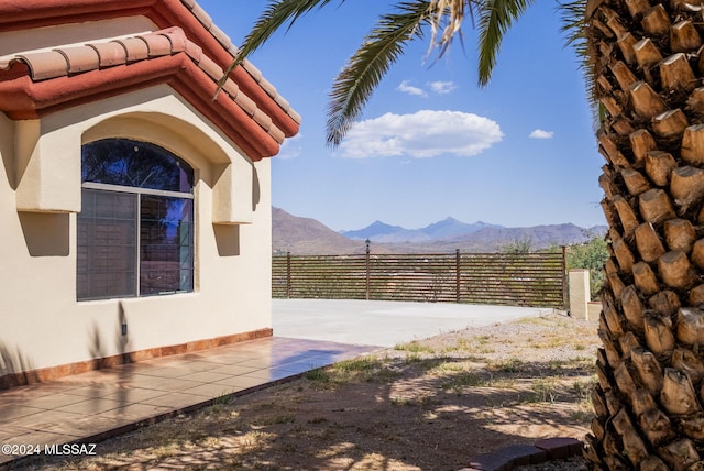 view of yard with a mountain view and fence