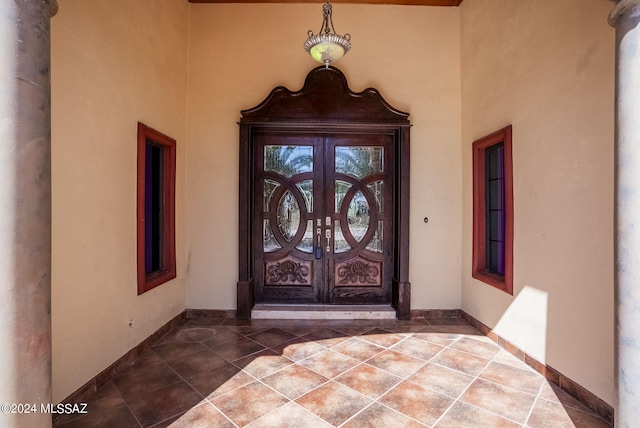 entrance to property featuring french doors and stucco siding