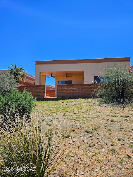 back of property featuring ceiling fan