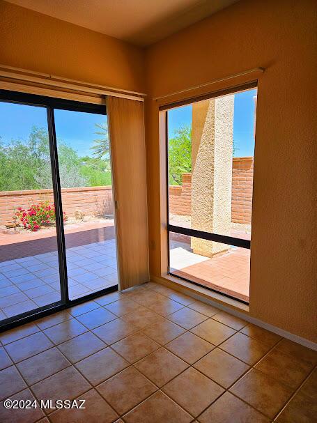 doorway to outside with tile patterned floors