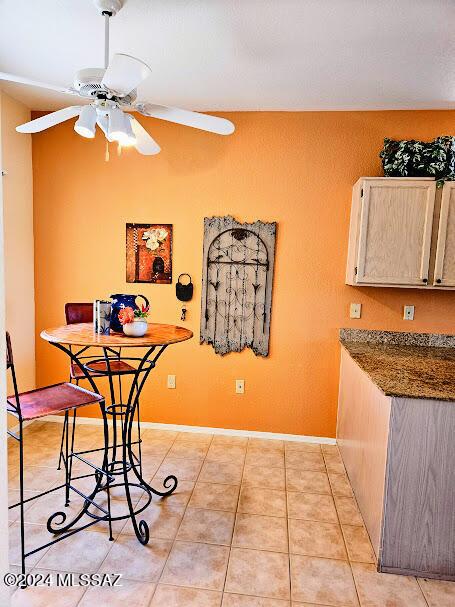 dining space featuring ceiling fan and light tile patterned flooring