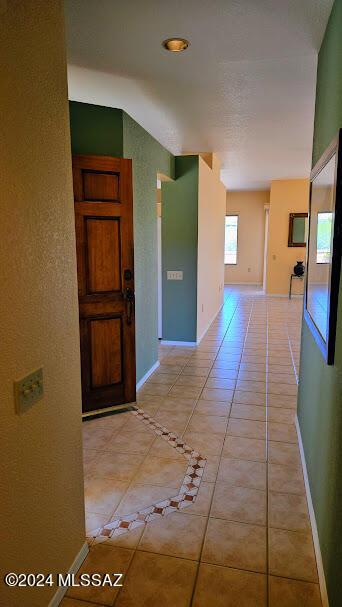 hall featuring light tile patterned flooring