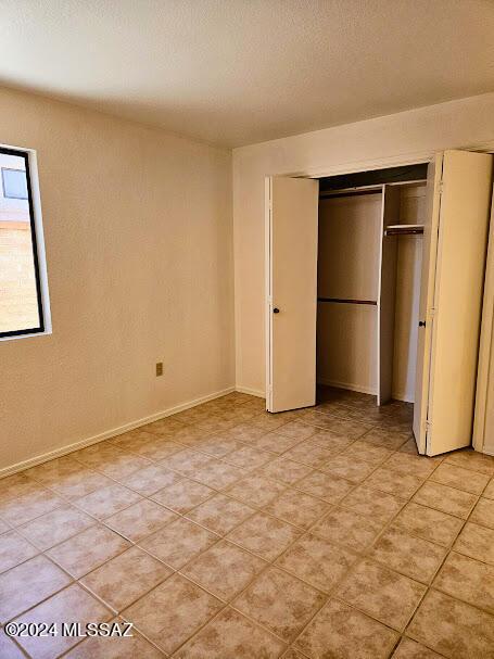 unfurnished bedroom with a closet