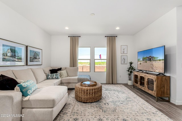 living area featuring recessed lighting, baseboards, and wood finished floors