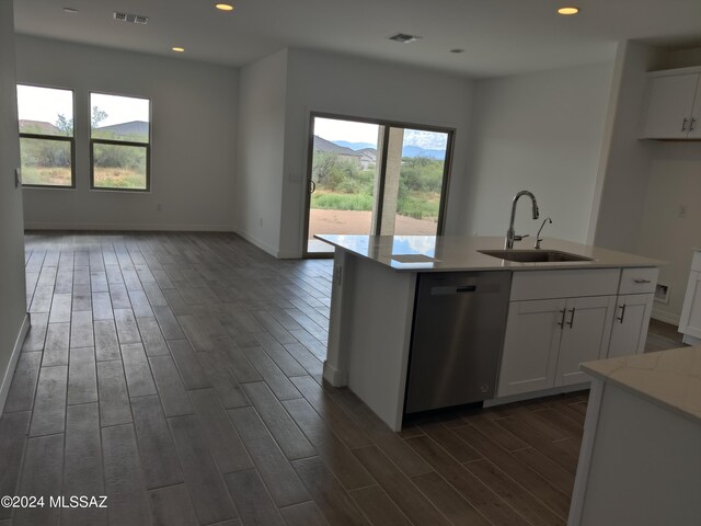 kitchen featuring dark hardwood / wood-style floors, an island with sink, white cabinetry, dishwasher, and sink