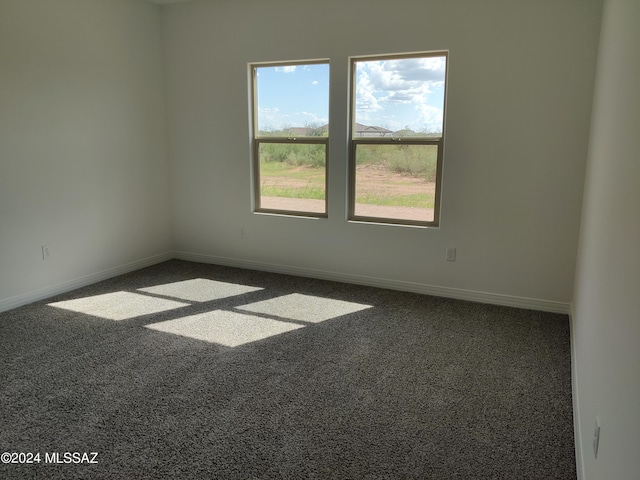 unfurnished room with baseboards