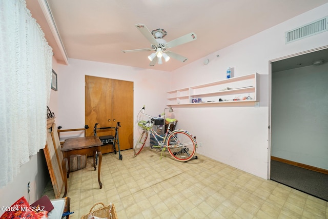 miscellaneous room with ceiling fan and light tile flooring