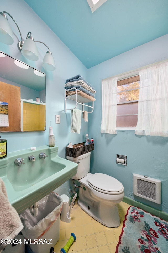 bathroom featuring tile flooring and toilet