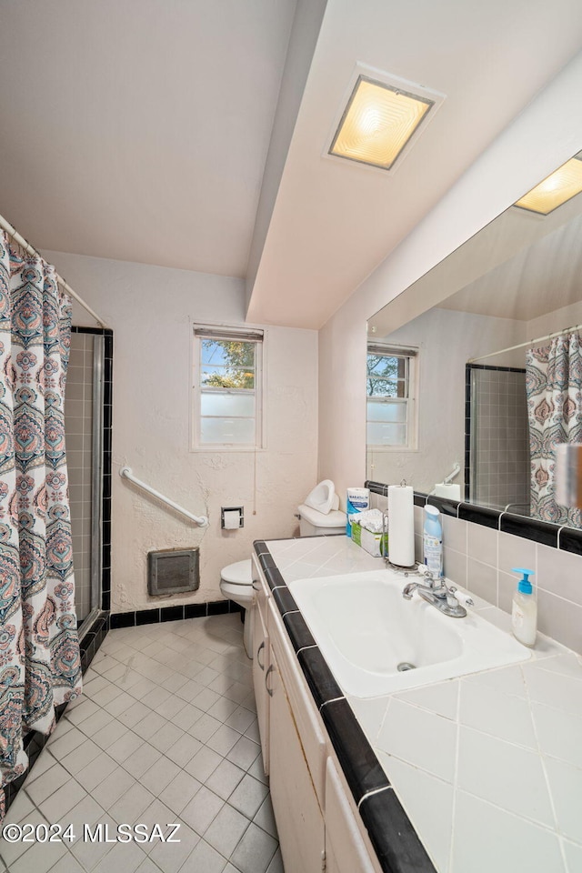 bathroom featuring tile flooring, toilet, and vanity