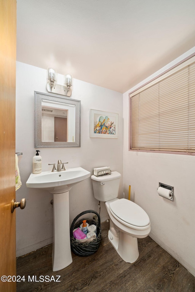 bathroom with toilet and wood-type flooring