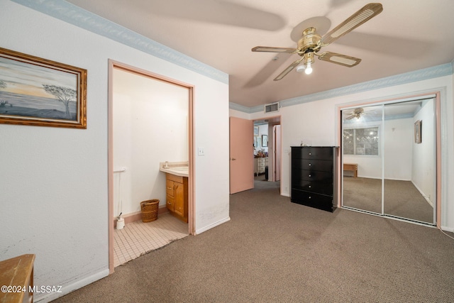 unfurnished bedroom featuring ceiling fan, a closet, and carpet flooring