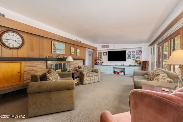 living room featuring lofted ceiling, wood walls, and light carpet