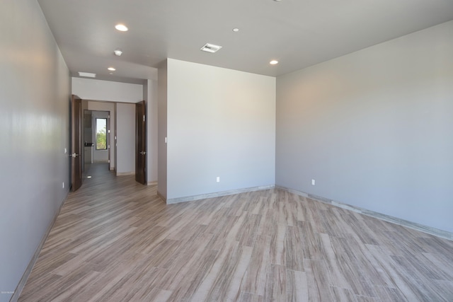 unfurnished room with light hardwood / wood-style flooring