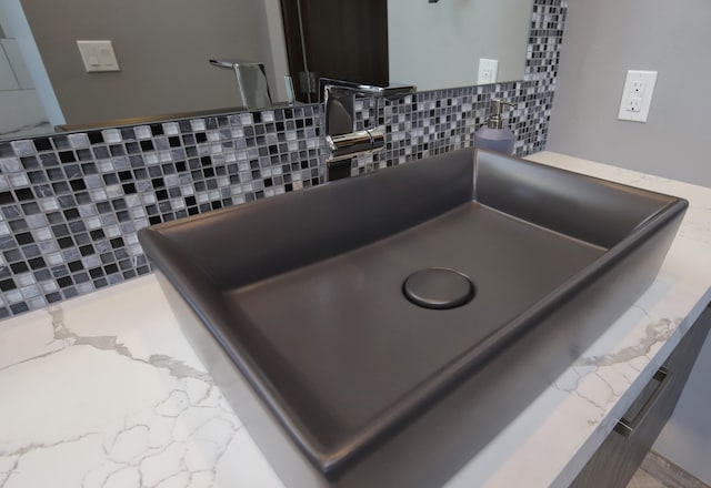 room details featuring tasteful backsplash and vanity