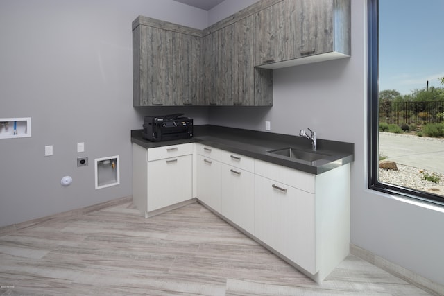 kitchen featuring white cabinets and sink