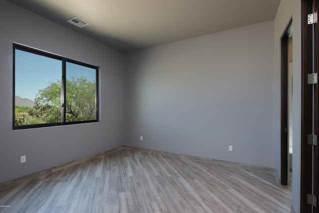 unfurnished room featuring light hardwood / wood-style floors