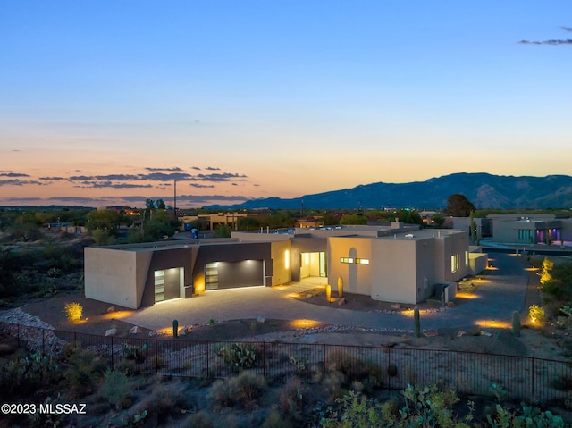 back house at dusk featuring a mountain view