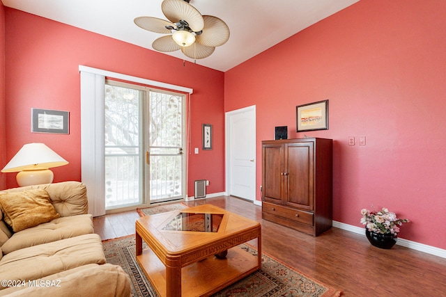 living room with ceiling fan and wood-type flooring