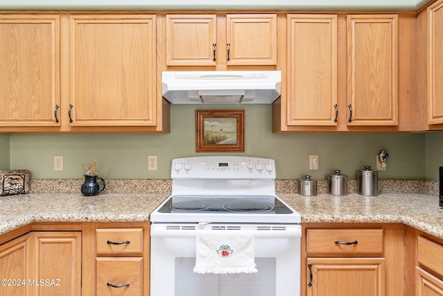 kitchen with wall chimney range hood, light stone counters, and white electric range