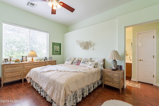 bedroom featuring ceiling fan, dark wood-type flooring, and connected bathroom