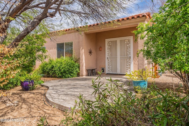 property entrance with a patio area