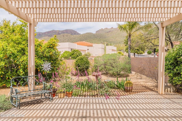 view of patio featuring a pergola and a mountain view