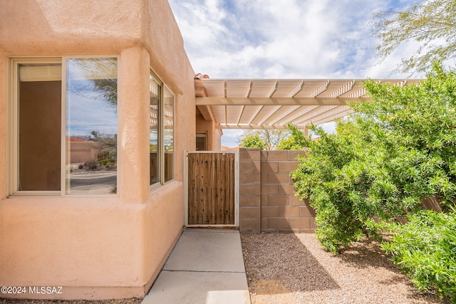 doorway to property featuring a pergola