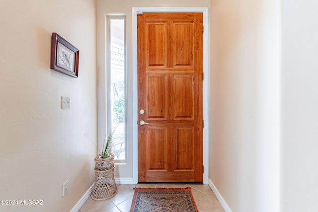 foyer entrance with a healthy amount of sunlight and light tile floors