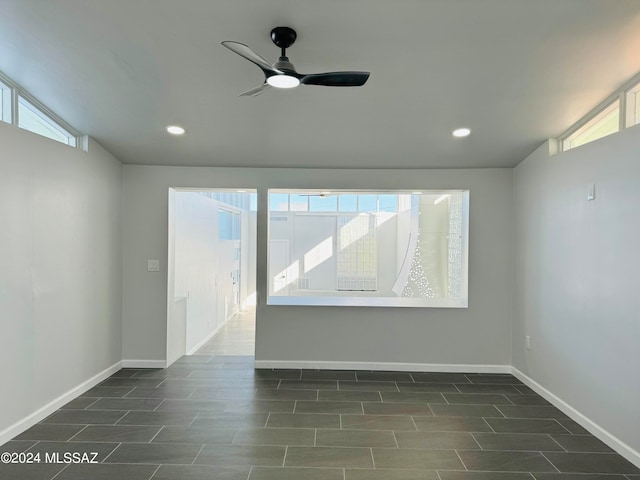 tiled spare room featuring ceiling fan and lofted ceiling