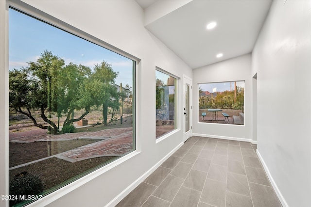 unfurnished sunroom with vaulted ceiling