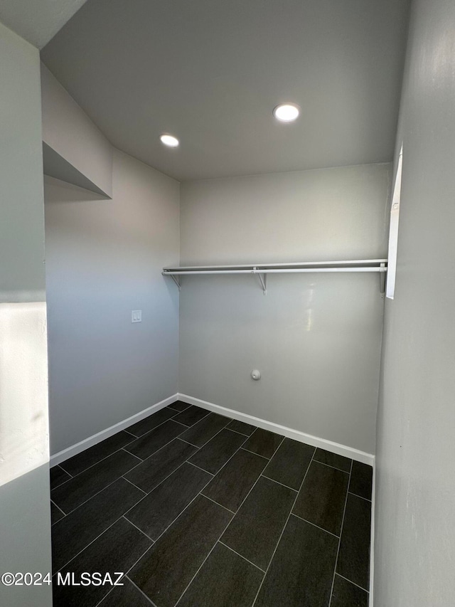 walk in closet with dark tile patterned floors