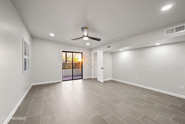 spare room with ceiling fan and tile patterned flooring