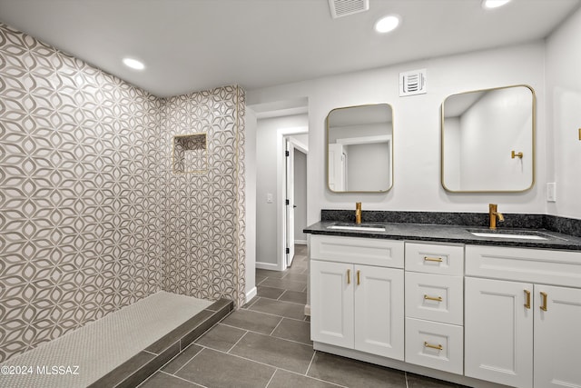 bathroom with tile patterned flooring and dual bowl vanity