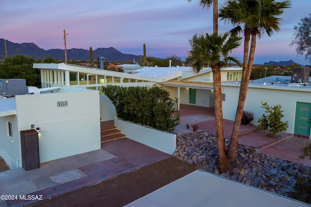 patio terrace at dusk with a mountain view