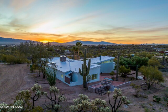 aerial view at dusk featuring a mountain view