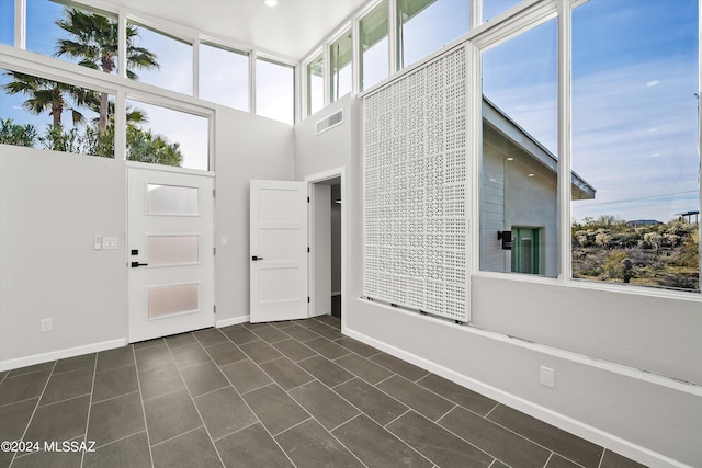 entrance foyer with dark tile patterned flooring