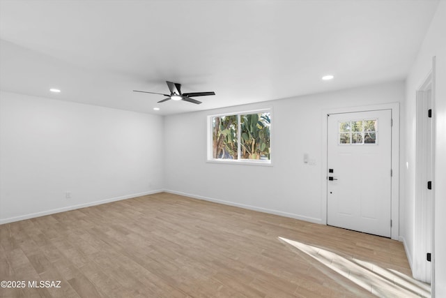 foyer entrance with light wood-type flooring, a wealth of natural light, baseboards, and recessed lighting