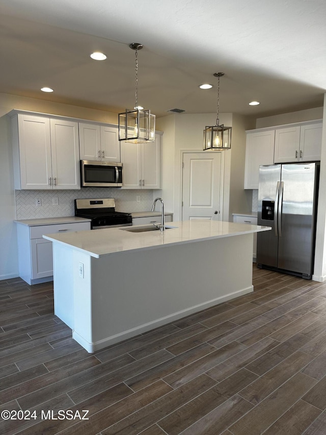 kitchen featuring white cabinets, sink, stainless steel appliances, and dark wood-type flooring