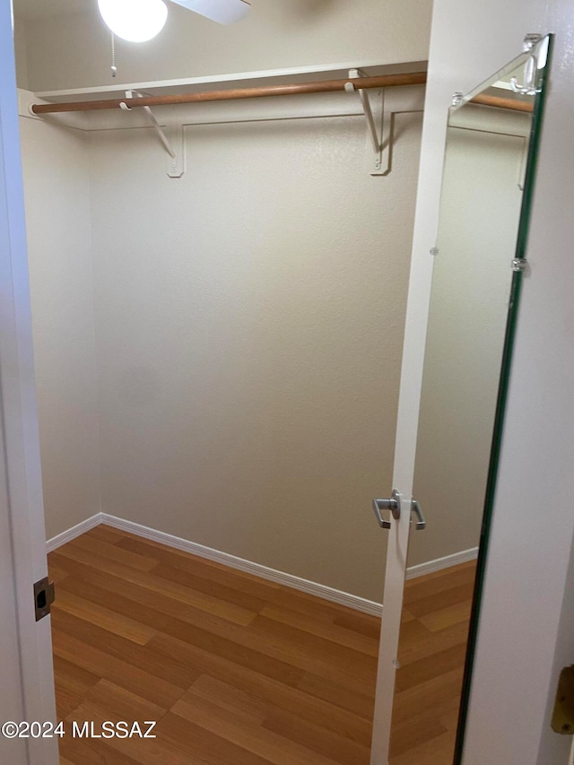 spacious closet with wood-type flooring and ceiling fan