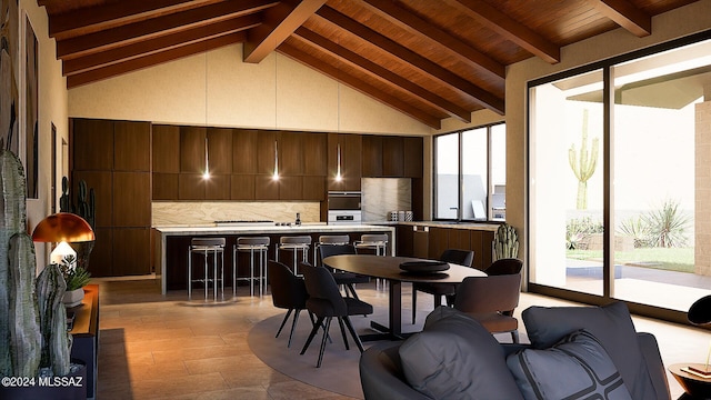 interior space with wood ceiling, plenty of natural light, vaulted ceiling with beams, and a stone fireplace