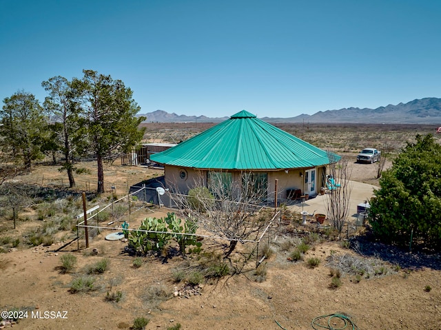 view of home's exterior with a rural view and a mountain view