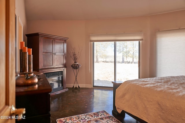 bedroom with access to exterior, vaulted ceiling, and multiple windows