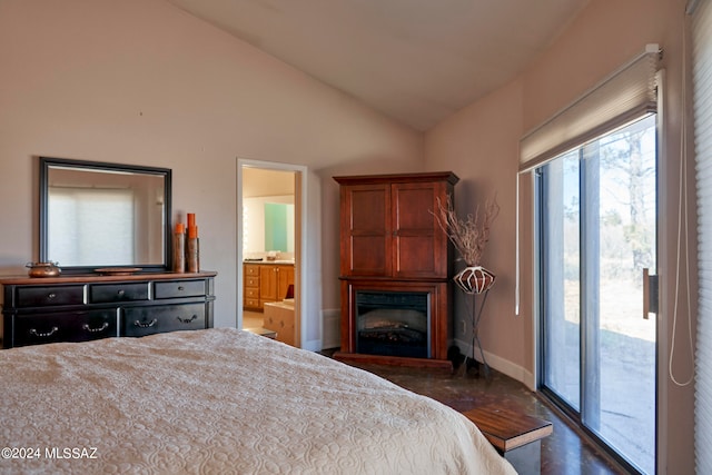 bedroom with ensuite bath, vaulted ceiling, and access to outside