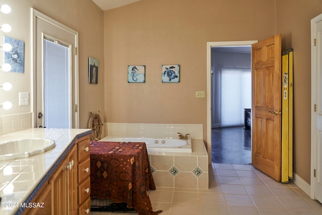 bathroom with lofted ceiling, a relaxing tiled bath, tile flooring, and vanity