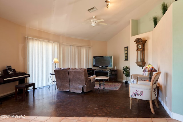 living room featuring light tile floors, ceiling fan, and vaulted ceiling