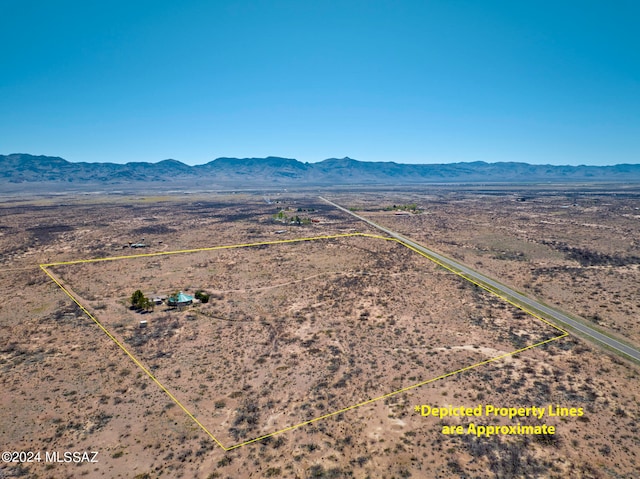 birds eye view of property with a mountain view