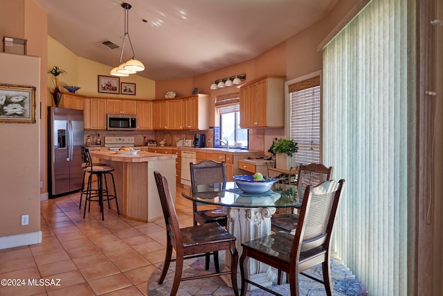 dining area with light tile floors and sink