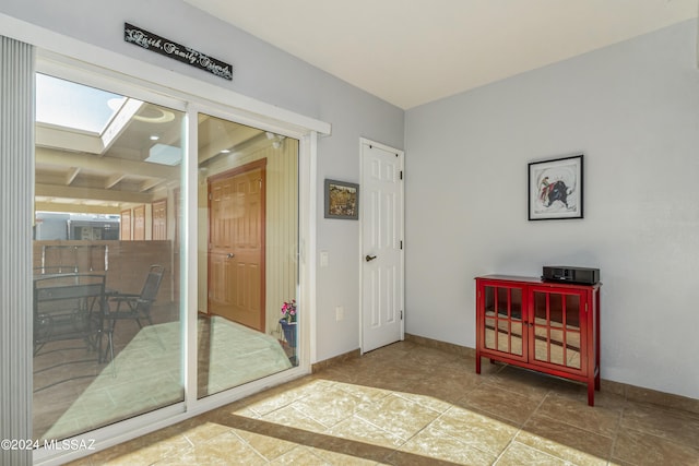 interior space with a skylight and tile patterned floors