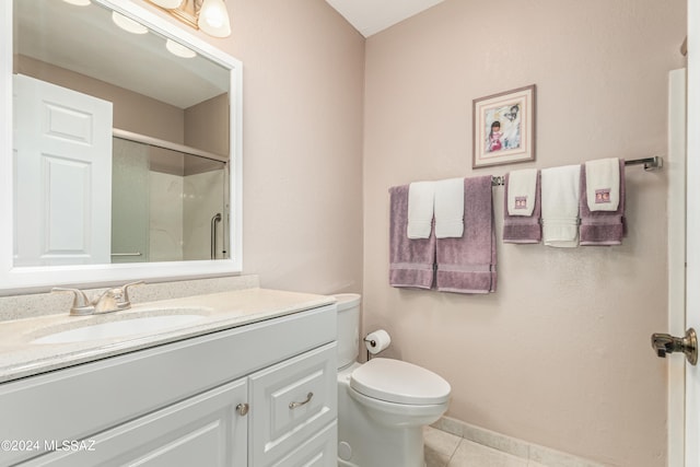 bathroom featuring toilet, tile patterned floors, walk in shower, and vanity